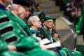 Photograph: [Seated members of the UNT Faculty on stage during commencement]