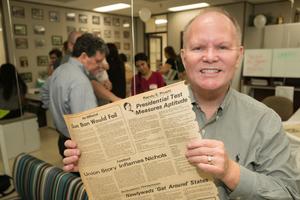 Primary view of object titled '[Randy Pruett Holding Campus Chat Clipping from 1976]'.