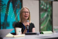 Photograph: [Karen Bjork Speaking Into Microphone at Conference]