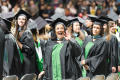 Primary view of [Masters Graduate Student Waving to Family and Friends at Commencement Ceremony]