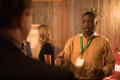 Photograph: [Conference attendee speaking with others]