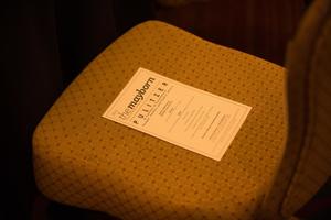Primary view of object titled '[Literary Lights Dinner schedule of events on chair]'.