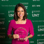 Primary view of [Cynthia Izaguirre holding up her award]