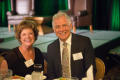 Photograph: [Jacqueline Kulick and Bob Kulick seated at table]