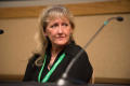 Primary view of [Carol Guzy sitting by microphone during panel session]