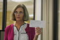 Photograph: [CSLA president Cheryl Cutchin holding up membership form]