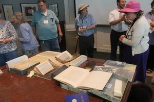 Primary view of object titled '[Attendees looking at archival books]'.