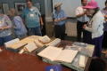 Thumbnail image of item number 1 in: '[Attendees looking at archival books]'.