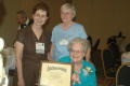 Primary view of [Caroline B. Cooney holding up award]