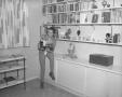 Primary view of [Bobbie Wygant in front of bookcase]