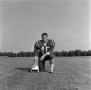 Photograph: [Football player kneeling with a helmet, 43]
