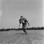Photograph: [Football player running on the field, 52]