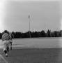 Photograph: [Referee running on the field]