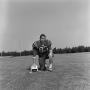 Photograph: [Football player kneeling with a helmet, 41]