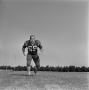 Photograph: [Football player running on the field, 55]