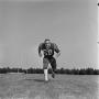Photograph: [Football player running on the field, 54]