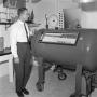 Photograph: [Dr. Donald Reddon with the decompression chamber #2]