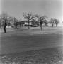 Photograph: [Clubhouse shot from green on golf course]
