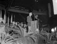 Photograph: [Gen. Wainwright giving a speech with men seated behind him]