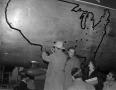 Primary view of [Bob Hope decorating an airplane]