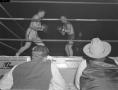 Photograph: [Two reporters watching a boxing match]