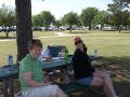 Photograph: [Two TNT members at picnic table]