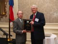 Photograph: [Gary Borders presenting Charles Moser with an award]