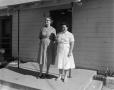 Primary view of [Two women standing on a porch]