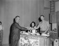 Photograph: [Budd Kneisel handing out drinks]