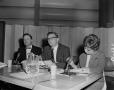 Photograph: [Three people sitting at table with microphones]