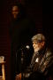 Photograph: [Photograph of Melvin Van Peebles and an unidentified man on a stage]