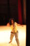 Photograph: [Photograph of a dancer in checkered pants standing on a stage]