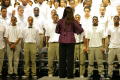 Photograph: [Choir members look toward the conductor]