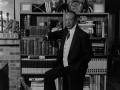 Photograph: [Photograph of Lee Bilal in front of bookcase]