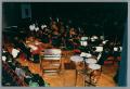 Primary view of [Photograph of a backstage view of the orchestra ensemble]
