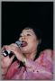 Photograph: [Close-up of Angela Bofill singing into microphone]