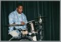 Primary view of [Photograph of a man playing a small drum set]