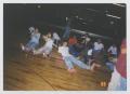 Photograph: [Photograph of TAMS students sitting at a skating rink]