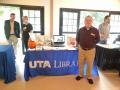 Photograph: [Jeff Downing at UTA Library display table]
