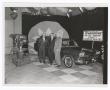 Photograph: [Men in front of a Rambler on the WBAP-TV set]