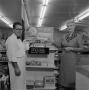 Photograph: [Man and woman in front of a store display at Cabell's]