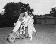 Photograph: [Man with young boys on a scooter at WBAP picnic]