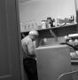 Photograph: [Man in a supply room]