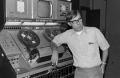 Photograph: [McClendon leaning on a machine]