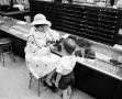 Photograph: [A women and a child at a store, 2]
