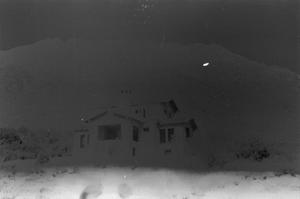 Primary view of object titled '[Photograph of a house in front of a mountain range]'.