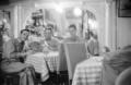 Primary view of [Photograph of men sitting in a restaurant]