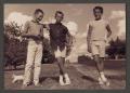 Photograph: [Photograph of three boys posing in a yard]