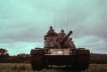 Photograph: [Three soldiers in a tank]