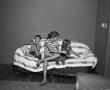 Photograph: [Byrd, Carol, and Pam on a striped couch]